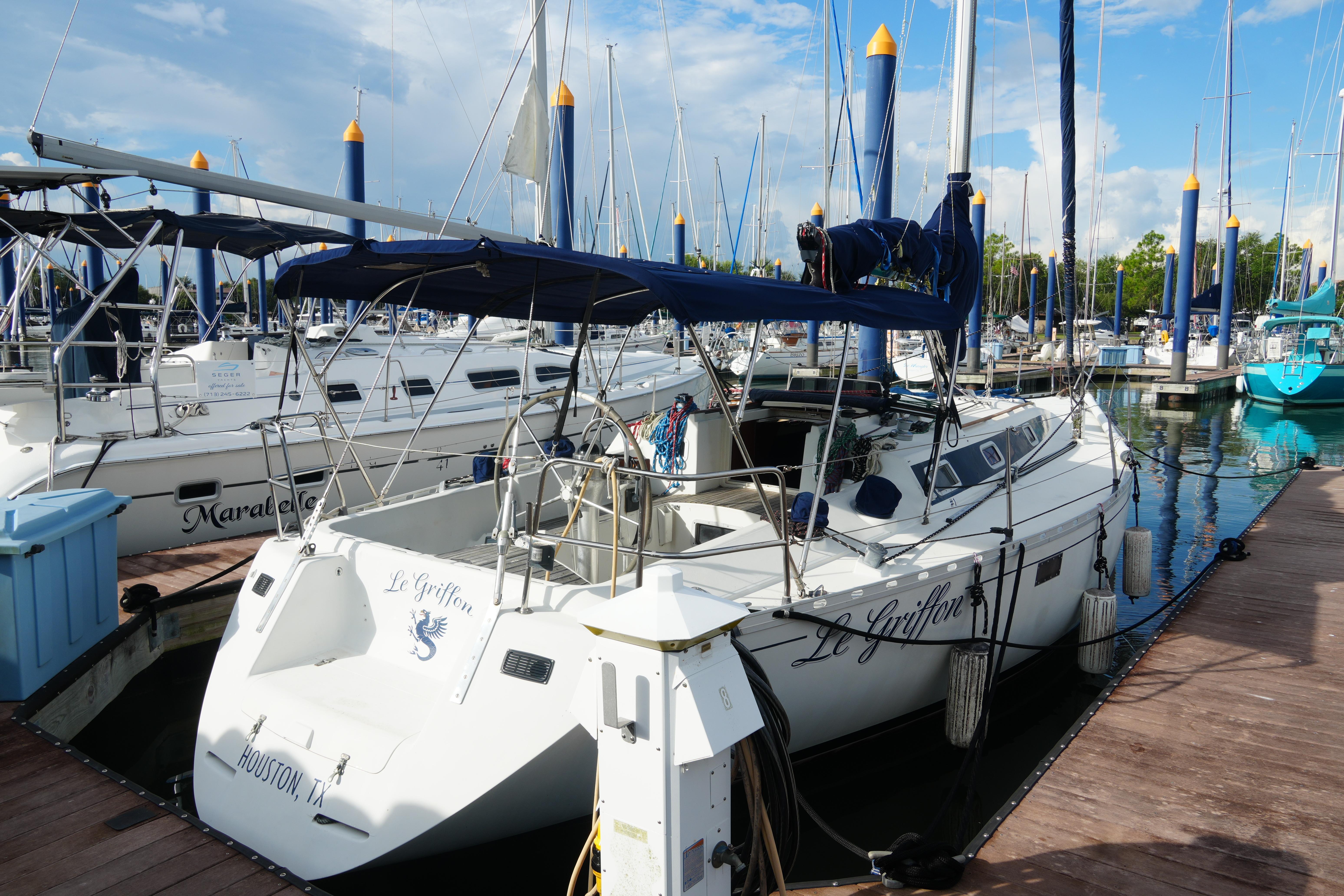 Beneteau First 38.5 1984 Beneteau First 38.5 sailboat docked at marina, named "Le Griffon."