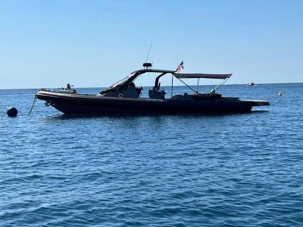 SACS 13 2019 SACS Strider 13 boat on calm blue water, side view.