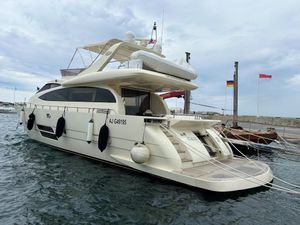 Leonard 66 Luxurious 2009 Leonard 66 yacht docked at marina, featuring sleek design and spacious deck.