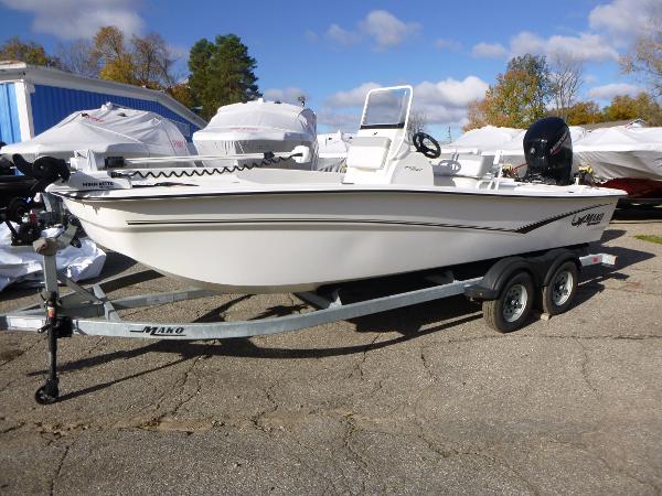 Mako 19CC 2022 Mako 19CC boat on trailer, parked outdoors, surrounded by other boats.