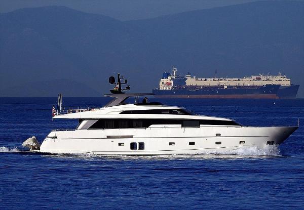 Sanlorenzo SL94 2013 Sanlorenzo SL94 yacht cruising on open water with a cargo ship in the background.