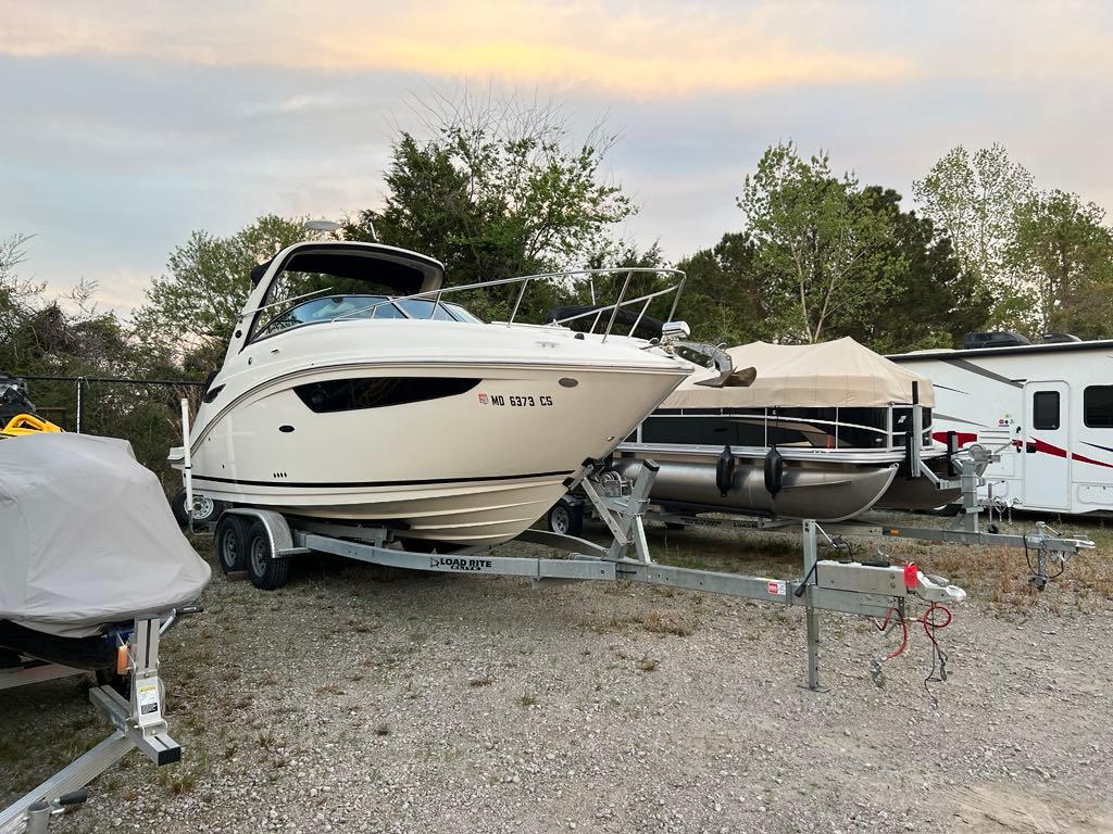 Sea Ray 260 Sundancer 2017 Sea Ray 260 Sundancer boat on trailer, parked outdoors near trees and RV.