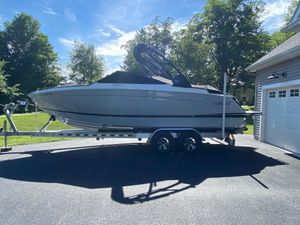 Cobalt R6 2023 Cobalt R6 boat on trailer in driveway, sunny day, surrounded by trees.