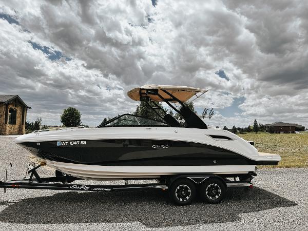Sea Ray SDX 250 2020 Sea Ray SDX 250 boat on trailer under cloudy sky.