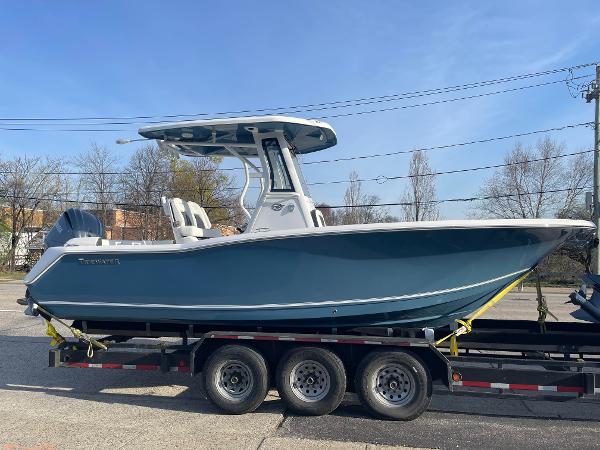 Tidewater 232 LXF 2025 Tidewater 232 LXF boat on trailer, side view, outdoors.