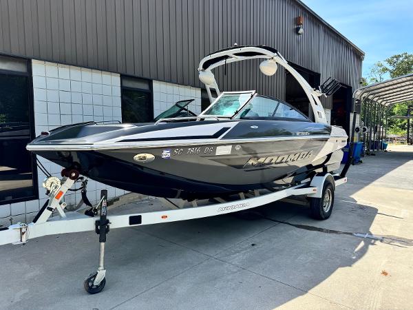 Moomba Mondo 2014 Moomba Mondo boat on trailer outside a building.