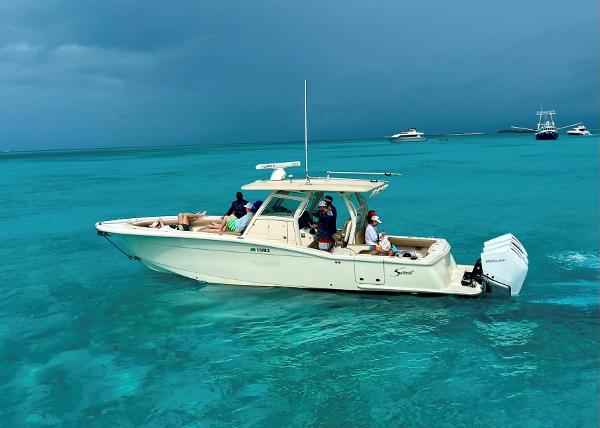 Scout LXF 350 2017 Scout LXF 350 boat cruising on clear turquoise waters.