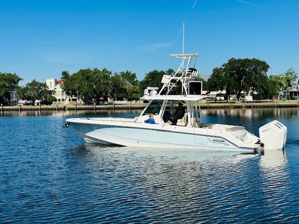 Boston Whaler 360 Outrage 2023 Boston Whaler 360 Outrage boat on calm water, clear sky, and scenic background.