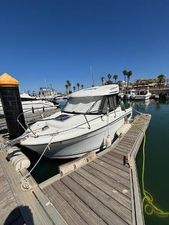 Jeanneau Merry Fisher 605 2017 Jeanneau Merry Fisher 605 docked at a sunny marina with palm trees.