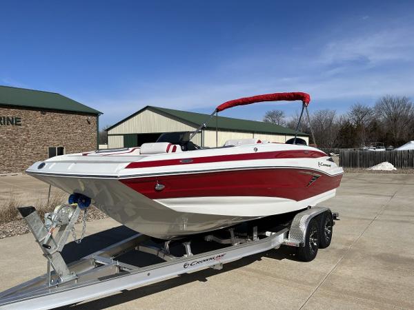 Crownline E205 xs 2023 Crownline E205 XS boat on trailer, red and white exterior, parked outdoors.