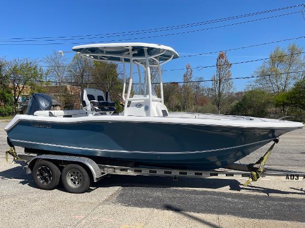 Tidewater 210 LXF 2025 Tidewater 210 LXF boat on trailer, side view, outdoors, clear sky.