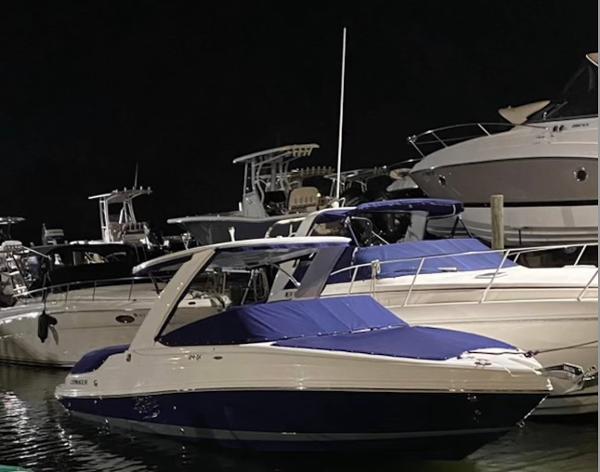 Rinker 29QX BR 2020 Rinker 29QX BR boat docked at night, surrounded by other vessels.