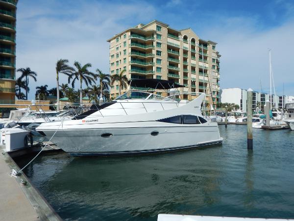 Carver 360 Mariner 2004 Carver 360 Mariner yacht docked at marina with palm trees and buildings in background.