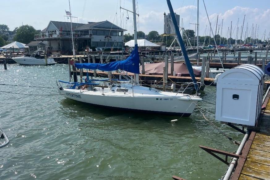 J Boats J/80 1995 J Boat J 80 sailboat docked at a marina with blue cover.