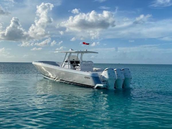 Intrepid 375 Center Console 2016 Intrepid 375 Center Console boat on clear blue water under a partly cloudy sky.