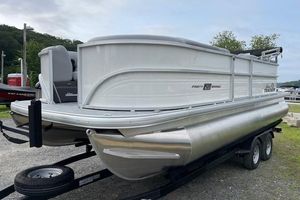 Sun Tracker Party Barge 20 DLX 2026 Sun Tracker Party Barge 20 DLX pontoon boat on trailer, parked outdoors.