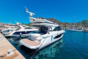 Princess F45 2021 Princess F45 yacht docked in a sunny marina, surrounded by clear blue water.