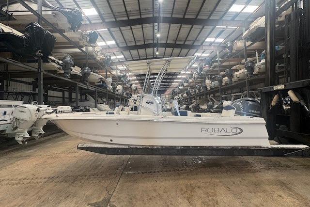 Robalo 206 Cayman 2022 Robalo 206 Cayman boat in storage facility, surrounded by other boats.