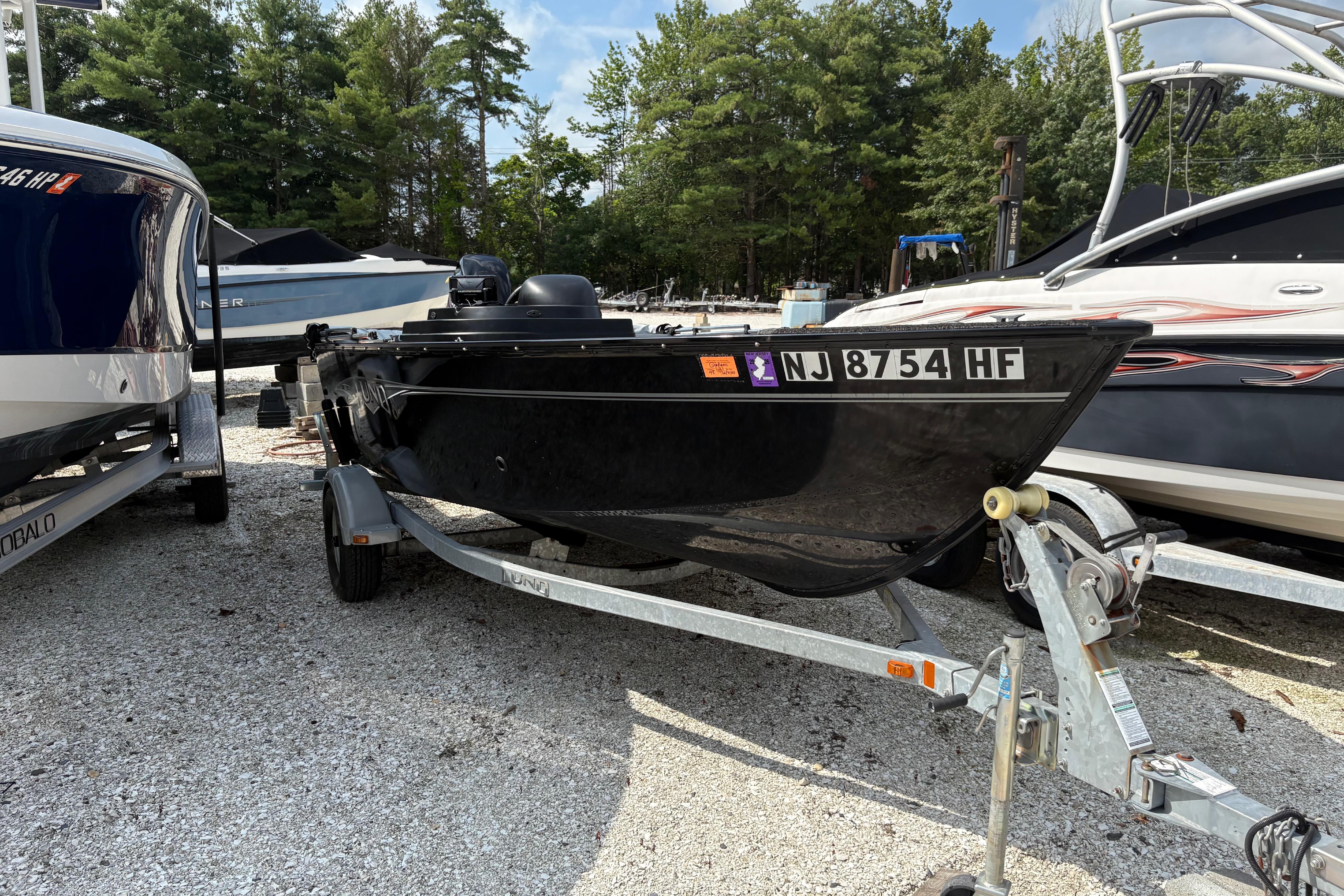 Lund 1650 Rebel XL Sport 2015 Lund 1650 Rebel XL Sport boat on trailer, parked among other boats.
