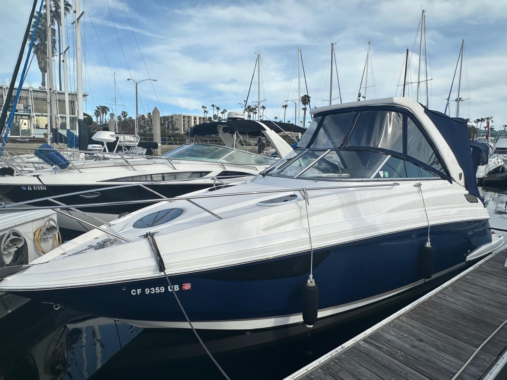 Regal 28 Express 2013 Regal 28 Express boat docked at marina with other vessels.