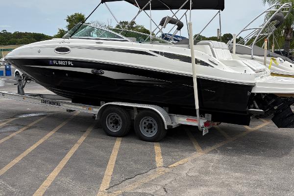 Sea Ray 260 Sundeck 2012 Sea Ray 260 Sundeck boat on trailer in parking lot.