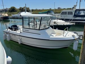 Smartliner Fisher 19 2023 Smartliner Fisher 19 boat docked in a marina, surrounded by other vessels.