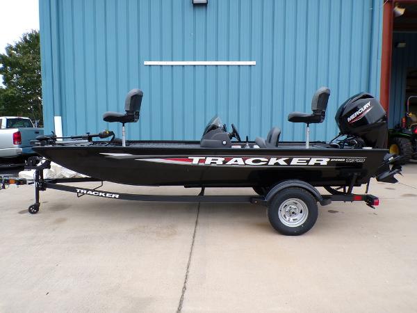 Tracker Pro 170 2025 Tracker Pro 170 boat on trailer, black exterior, parked by blue building.