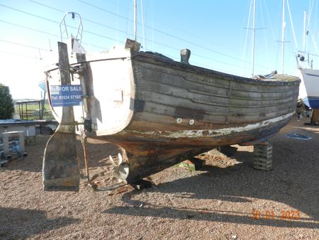 England, Kent, Deal. Old wooden fishing boat on the shingle