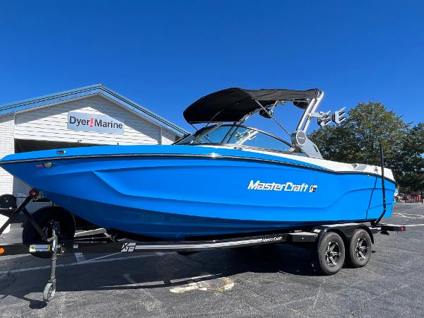 MasterCraft XT24 2024 MasterCraft XT24 boat in vibrant blue on trailer at Dyer Marine.