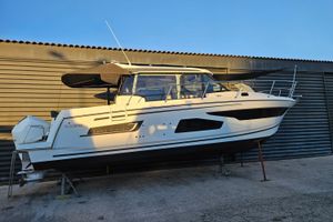 Jeanneau Merry Fisher 1095 2021 Jeanneau Merry Fisher 1095 boat on stands, side view, in a storage area.
