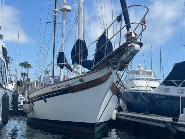 Bluewater Vagabond 47 1983 Bluewater Vagabond 47 sailboat docked in marina, clear sky background.