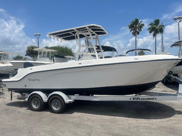 Bayliner Trophy T22CC 2022 Bayliner Trophy T22CC boat on trailer, parked outdoors under a blue sky.