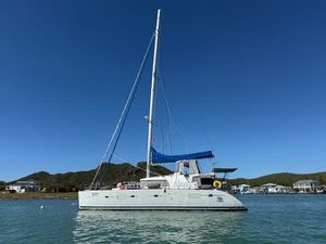 Lagoon 500 2009 Lagoon 500 catamaran anchored in calm waters under clear blue sky.