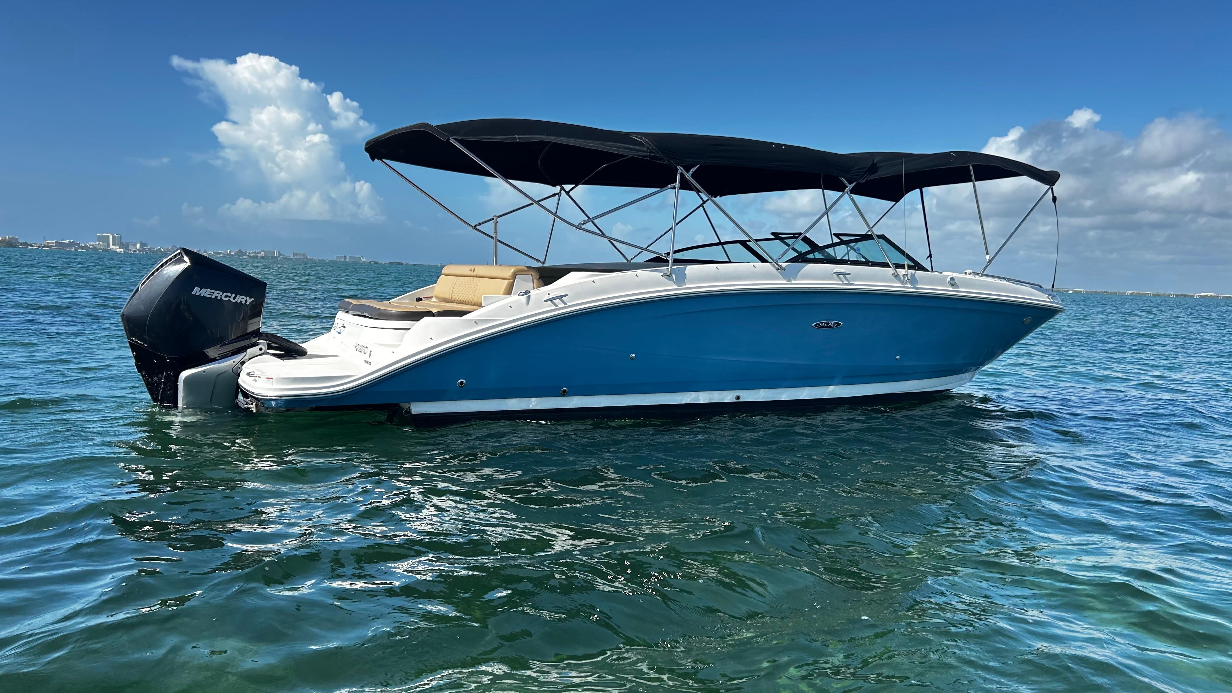 Sea Ray SDX 270 Outboard 2020 Sea Ray SDX 270 Outboard boat on calm blue water under clear sky.