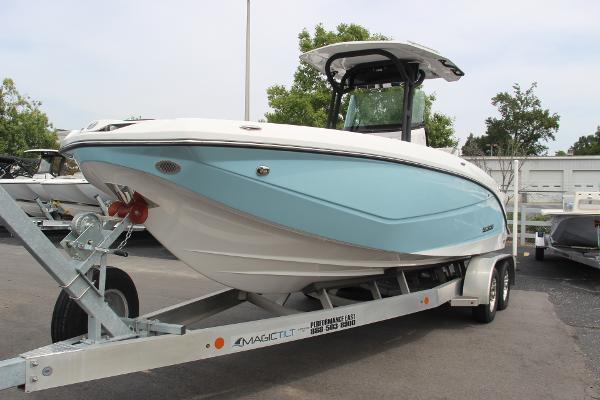 Scarab 255 Open ID 2023 Scarab 255 Open ID boat on trailer, light blue hull, parked outdoors.