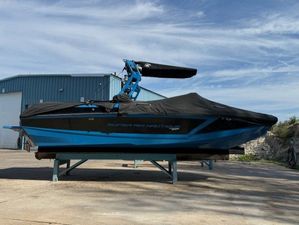 Nautique Super Air Nautique GS22 2018 Nautique Super Air Nautique GS22 boat with cover, parked outdoors.