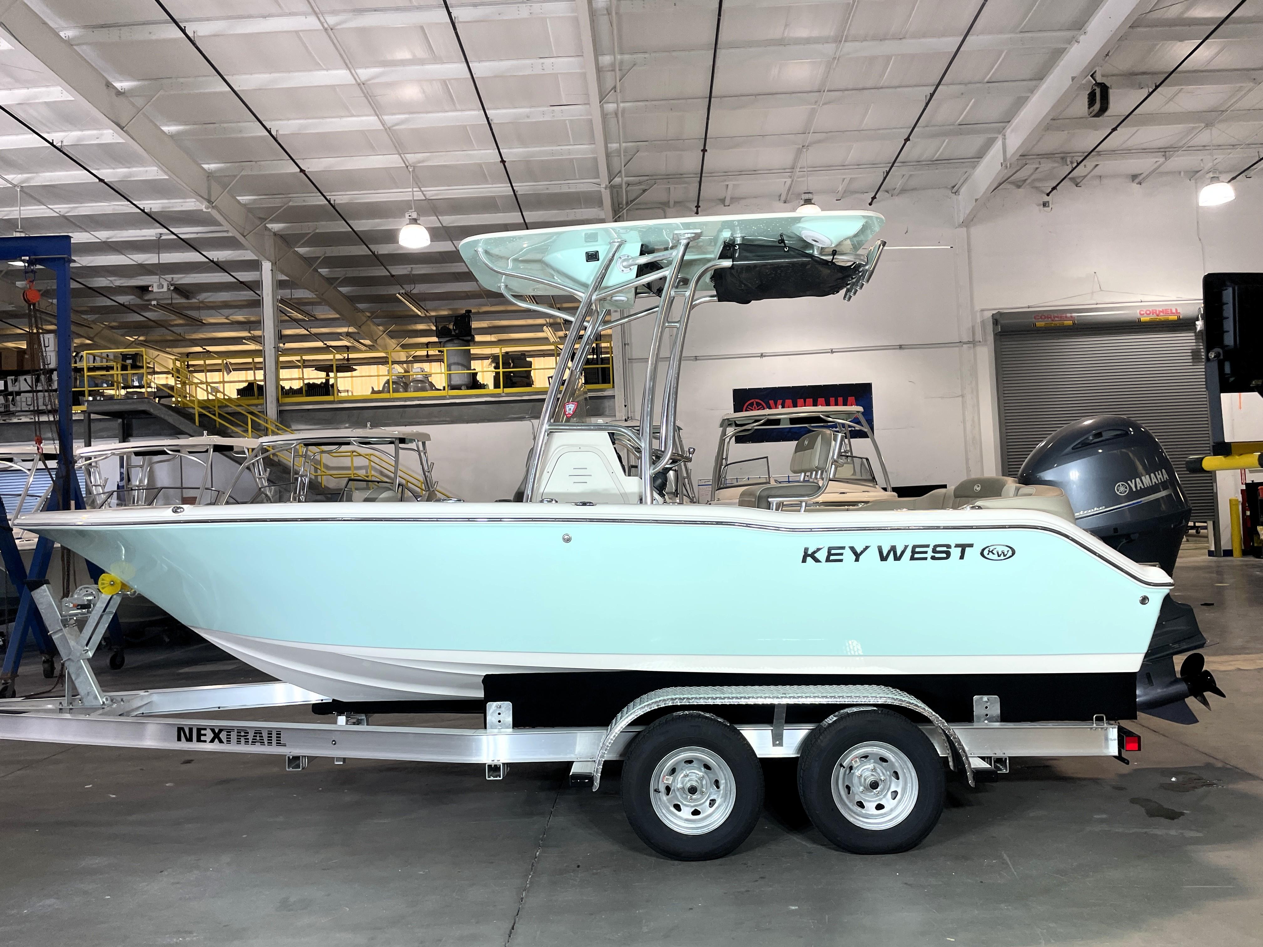 Key West 203 FS 2023 Key West 203 FS boat on trailer in indoor showroom.
