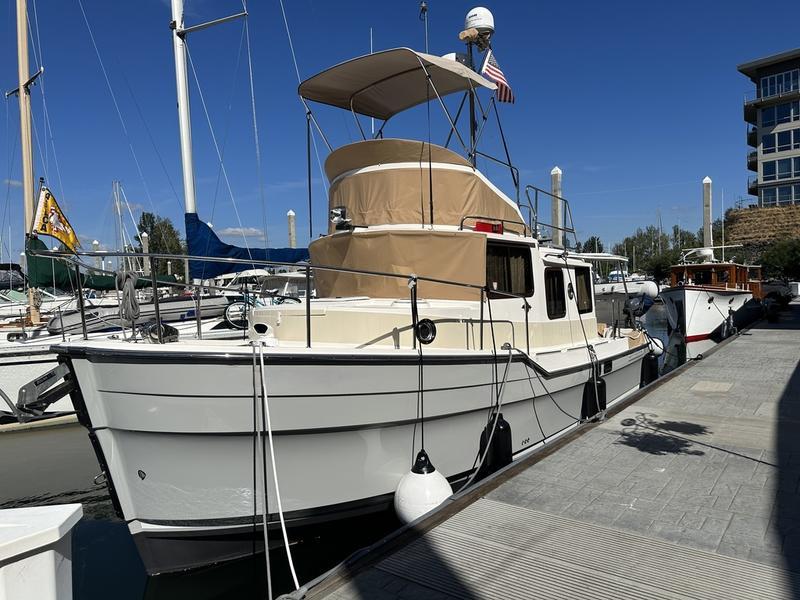 Ranger Tugs R-31 CB 2021 Ranger Tugs R-31 CB docked at marina under clear blue sky.