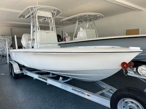Contender 23 Bay 2025 Contender 23 Bay boat on trailer in showroom.