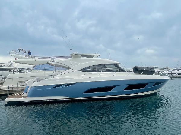 Riviera 4800 Sport Yacht 2020 Riviera 4800 Sport Yacht docked in marina, sleek design, blue and white exterior.