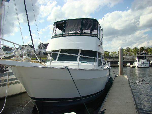 Mainship 430 Trawler 2001 Mainship 430 Trawler docked at a marina under a partly cloudy sky.