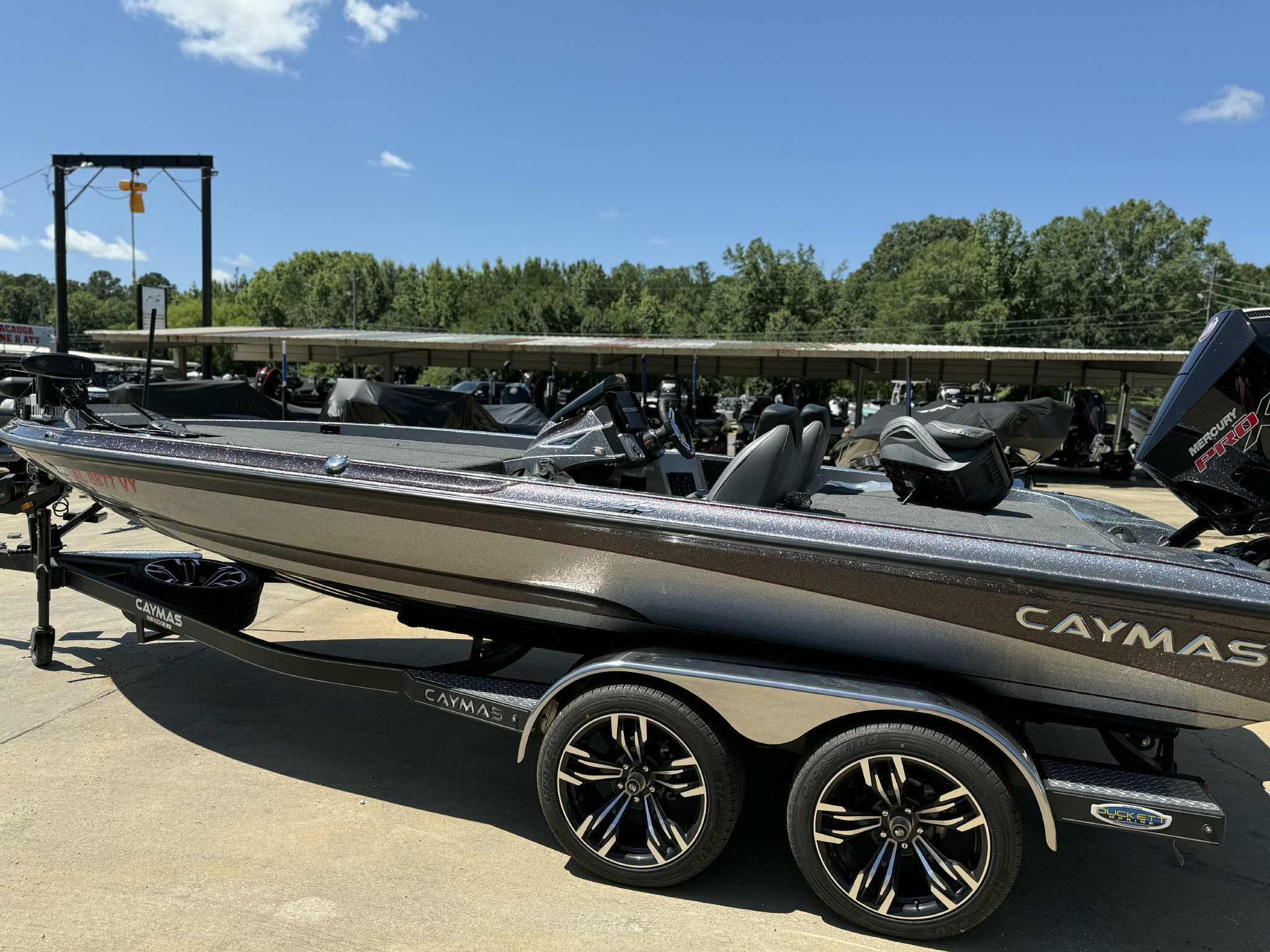 Caymas CX 20 2023 Caymas CX 20 boat on trailer, parked outdoors under clear blue sky.