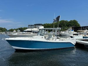 Edgewater 285CC 2023 Edgewater 285CC boat docked in a marina on a sunny day.