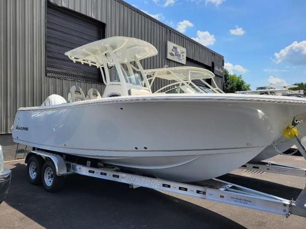 Sailfish 241 CC 2025 Sailfish 241 CC boat on a trailer outside a warehouse.