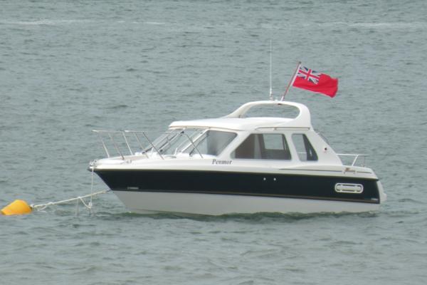 Yamarin 74c 2009 Yamarin 74c boat with red flag, anchored on calm water.
