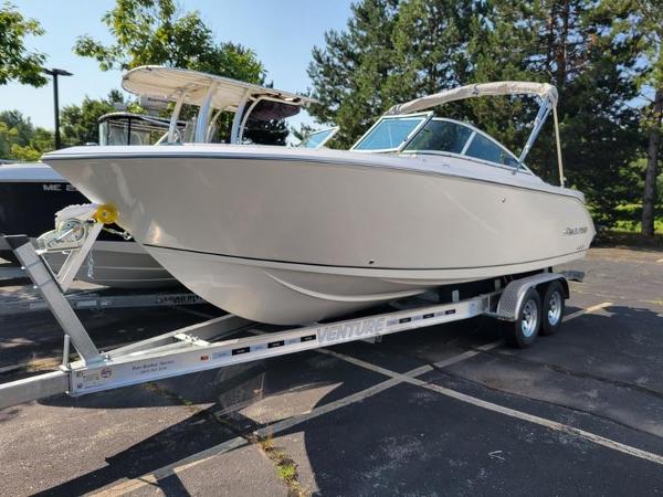 Sailfish 236 DC 2025 Sailfish 236 DC boat on trailer in sunny parking lot.