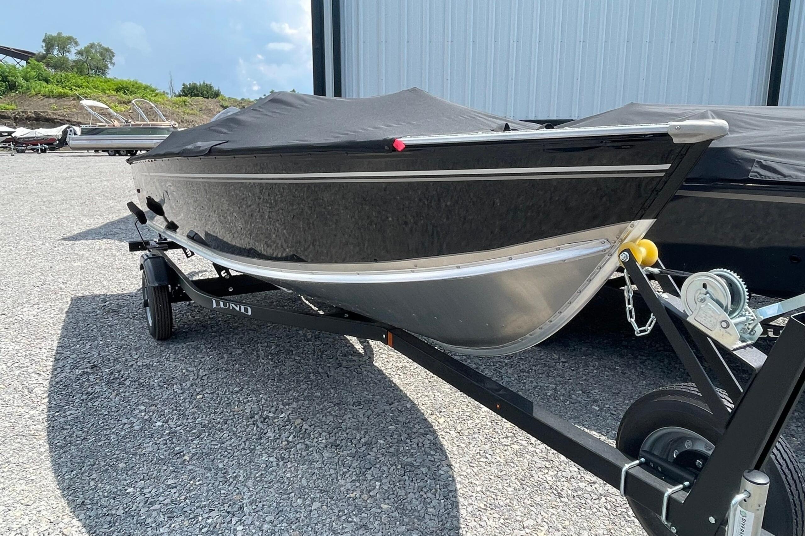 Lund 1600 Fury SS 2026 Lund 1600 Fury SS boat on trailer, covered and parked outdoors.