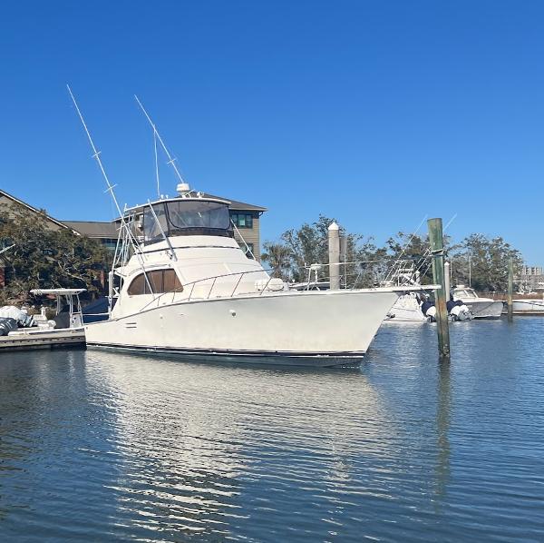Post 46 Sport Fisherman 1988 Post 46 Sportfish boat docked in a marina under clear blue skies.