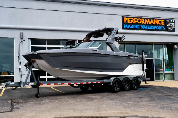 MasterCraft XStar 25 2025 MasterCraft XStar 25 boat on trailer outside Performance Marine Watersports store.
