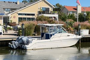 Robalo R245 Walkaround 2014 Robalo R245 Walkaround boat docked near waterfront homes.